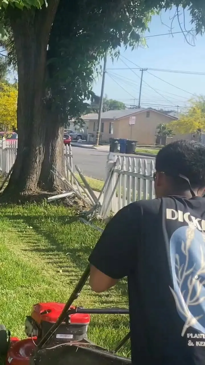 Landscaping Plus mowing a front lawn